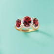 3.90 ct. t.w. Garnet and .27 ct. t.w. Diamond Three-Stone Ring in 14kt Yellow Gold