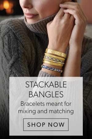Stackable Bangles. Mix and Match on-Trend Bracelets. Shop Now. Image Featuring Model Wearing Gold Bangles on Both Wrists