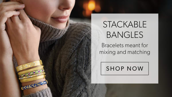 Stackable Bangles. Mix and Match on-Trend Bracelets. Shop Now. Image Featuring Model Wearing Gold Bangles on Both Wrists
