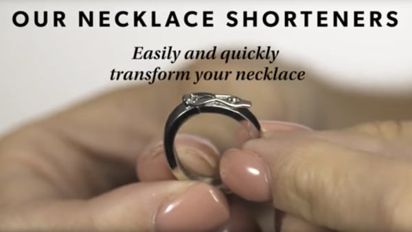 Necklace shortener YouTube video. Fingers holding necklace shortener.