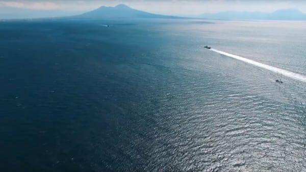 Italian cameo YouTube video. Vast sea with boats and island in distance.