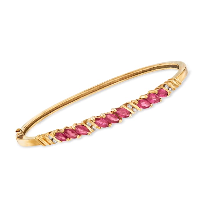 C. 1980 Vintage 2.70 ct. t.w. Ruby and .20 ct. t.w. Diamond Bangle Bracelet in 14kt Yellow Gold
